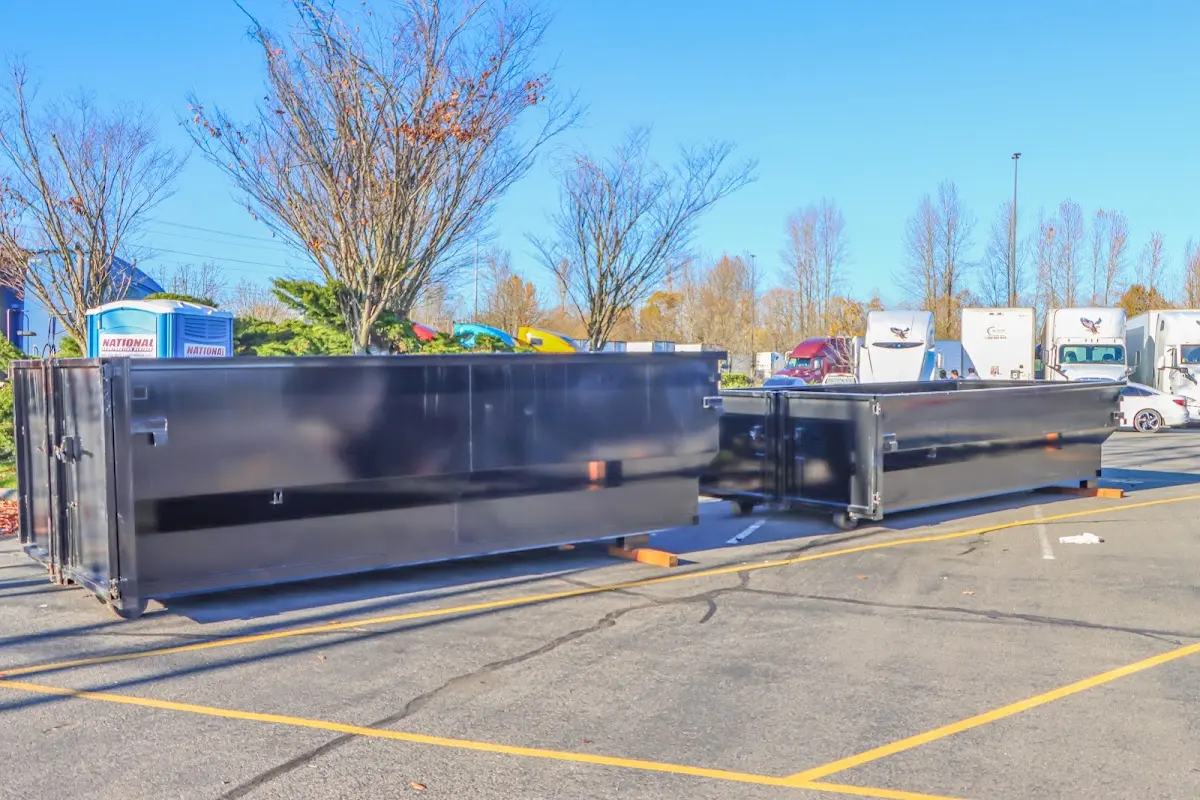 Professional dumpster rental service with roll-off container on residential driveway in Berwyn